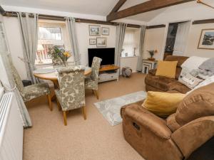 a living room with a couch and a table at Dales Barn Top in Hawes