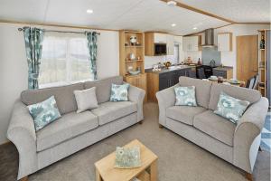 a living room filled with furniture and a couch at Newquay Bay Resort in Newquay