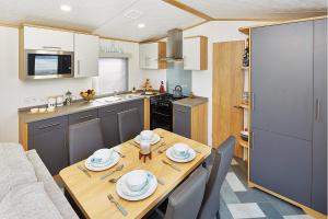 a kitchen that has a table and chairs in it at Newquay Bay Resort in Newquay