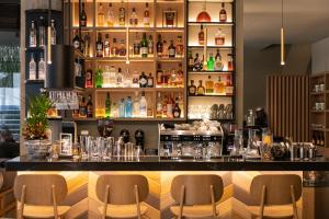 a bar with a lot of bottles of alcohol at S Hotel Boutique Thessaloniki in Thessaloniki