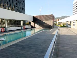 a swimming pool in front of a building at Goizeder apartment by People Rentals in Bilbao