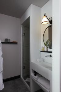 a white bathroom with a sink and a shower at Drawing House in Paris