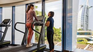 two women walking on a treadmill in a gym at Jumeirah Beach Hotel Dubai in Dubai