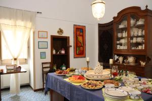 a table filled with plates and bowls of food at B&B Il Giardino di Paola in Alliste