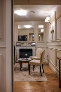 a living room with a chair and a fireplace at Matilde Boutique Hotel in Milan