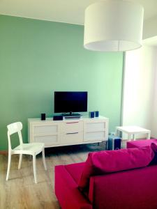 a living room with a couch and a tv at Casa Julia in Cividale del Friuli