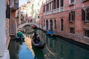 Ein paar Gondeln in einem Kanal in einer Stadt in der Unterkunft Ve.N.I.Ce Cera San Moisè in Venedig