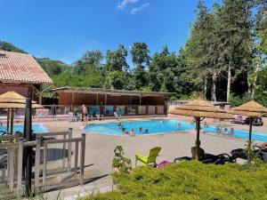 a large swimming pool with people in it at Camping Les Foulons in Tournon-sur-Rhône