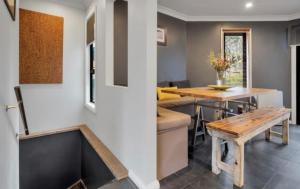 a kitchen and dining room with a table and a bench at Snowcreek 2 Alpine Chalet, Private Garage in Thredbo