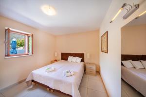 a bedroom with two beds and a window at Apartment Vala in Zaton