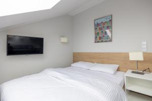 Postel nebo postele na pokoji v ubytování Aparthotel Esencja Warszawy Nowy Świat