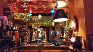 a bar with christmasmas lights and a mirror at Westholme Hotel in Blackpool