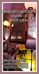a room with a mirror and a table with a vase of flowers at Westholme Hotel in Blackpool