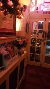 a room with a christmas tree outside a door at Westholme Hotel in Blackpool
