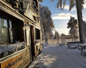 a building with snow on the windows and a bench at Waldeck Oberwiesenthal in Kurort Oberwiesenthal