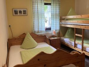 a bedroom with two bunk beds and a window at Waldeck Oberwiesenthal in Kurort Oberwiesenthal