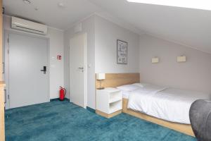 Postel nebo postele na pokoji v ubytování Aparthotel Esencja Warszawy Nowy Świat