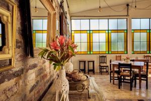 a room with stained glass windows and a table with a vase with flowers at El Rubicón (casa de campo) in Concepción del Uruguay
