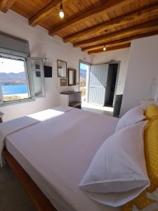 リバディオンにあるAsteroskoni of Serifosの窓付きの客室で、白い大型ベッド1台が備わります。