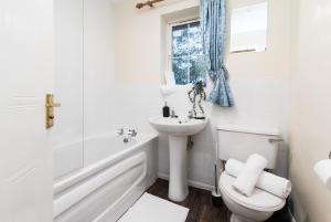 a white bathroom with a toilet and a sink at Coventry- Perchfoot 3 Bedroom Contractor and Pet-Friendly Spacious House By Sublime Stays in Parkside +17 photos