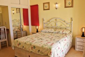 a bedroom with a bed and a mirror at Villa Santa Barbara by Portucasa in Bordeira +20 photos