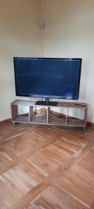 a flat screen tv sitting on a entertainment center at Ferienwohnung Landidylle in Wörpen