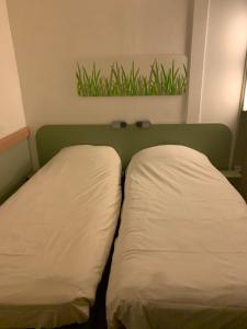 Postel nebo postele na pokoji v ubytování ibis budget Chambéry Sud Challes Les Eaux