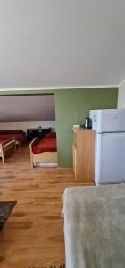 a room with a bed and a refrigerator in it at Noclegi u Lili in Człuchów