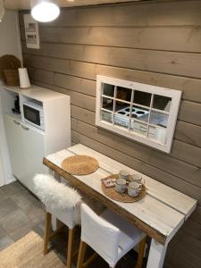a small kitchen with a table and a refrigerator at Villa Pyhäjärvi in Tampere