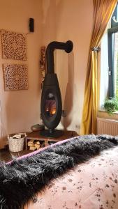 a stove in a room with a bed in front of it at Boutique Apartments Benz I-III in Bergisch Gladbach