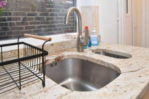 a kitchen sink with a granite counter top at The Yellow Door by Avenew Management Serviced Accommodation in Stoke on Trent