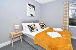 a small bedroom with a bed and a window at The Yellow Door by Avenew Management Serviced Accommodation in Stoke on Trent