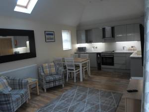 a kitchen and living room with a table and chairs at Viking Villa in Broadstairs