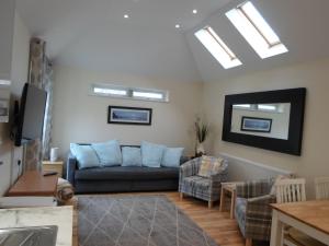 a living room with a couch and chairs and skylights at Viking Villa in Broadstairs