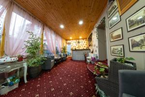 a living room with a room with plants on the walls at La Casa Nord in Bucharest