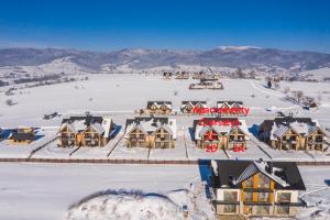 an aerial view of a resort in the snow at udanypobyt Apartamenty Czorsztyn in Kluszkowce