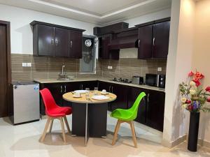 a kitchen with a table and two chairs and a counter at Marine Tower in Rawalpindi