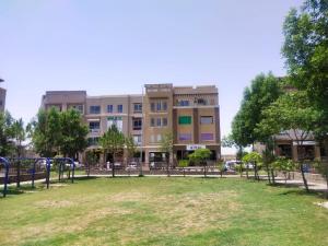 a park in front of a large building at Marine Tower in Rawalpindi