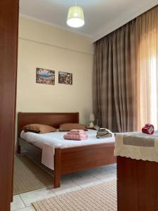 a bedroom with a bed and a window at Suzie's House - Road to Loutra Pozar in Polykárpion
