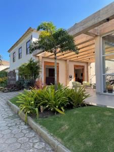 uma casa com uma palmeira em frente em Pousada Villa Alferes em Tiradentes