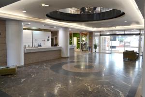 a lobby with a large circular ceiling in a building at Hotel Alda Sada Marina in Sada