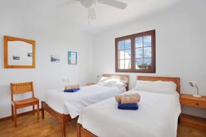 a bedroom with two beds with a teddy bear on them at Puerto Chico R in Playa Blanca +16 photos