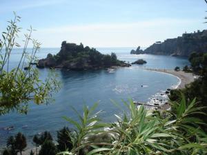 a view of a beach with people in the water at Villa La Spada in Taormina +16 photos
