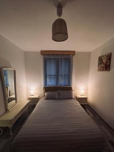 a bedroom with a large bed with two lamps on the sides at Apartament Aretta in Braşov