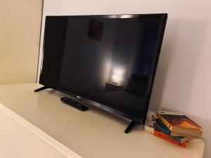 a television sitting on a table with a remote control at Apartament Aretta in Braşov