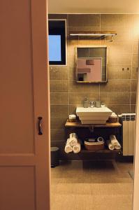 a bathroom with a sink and a mirror at Apartament Aretta in Braşov +45 photos