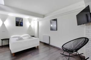 a white bedroom with a bed and a chair at CMG-Cosy Apartment-Parc des Princes-Stade Rolland Garros in Boulogne-Billancourt