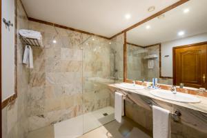 a bathroom with a sink, toilet and mirror at Bahia Principe Sunlight San Felipe in Puerto de la Cruz