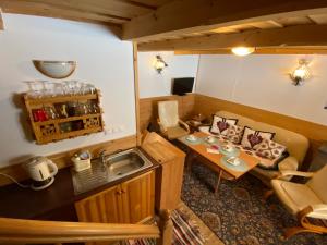 a kitchen and a living room with a table at Domki Camping Harenda in Zakopane