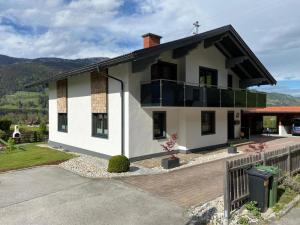 a large white house with a balcony at Mountain Love Appartements in Haus im Ennstal